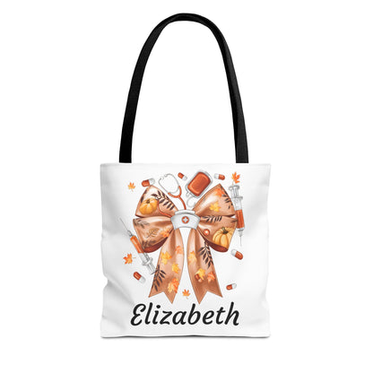 Personalized fall nurse tote bag featuring a bow, medical tools, and the name 'Elizabeth', perfect for autumn gifts.